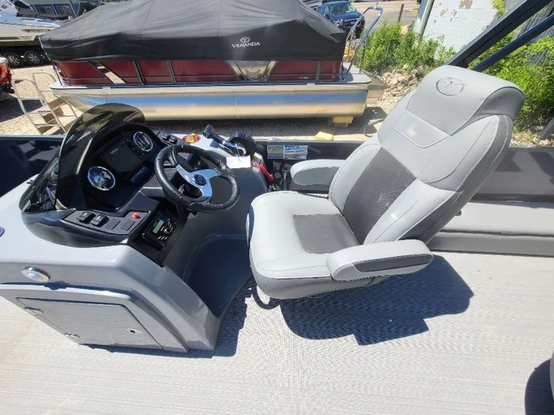 Slide: The Image of 2022 Veranda VF22F4 Deluxe Tri-Toon boat cockpit with captain's chair and control panel. - 7