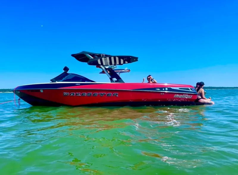 Slide: The Image of 2013 Malibu Wakesetter 247LSV boat on a sunny lake. - 4