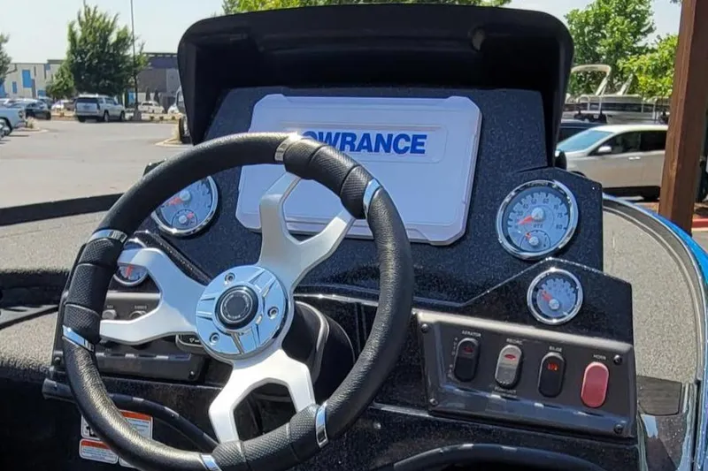 Slide: The Image of 2023 Nitro Z18 boat dashboard with steering wheel and Lowrance display. - 2