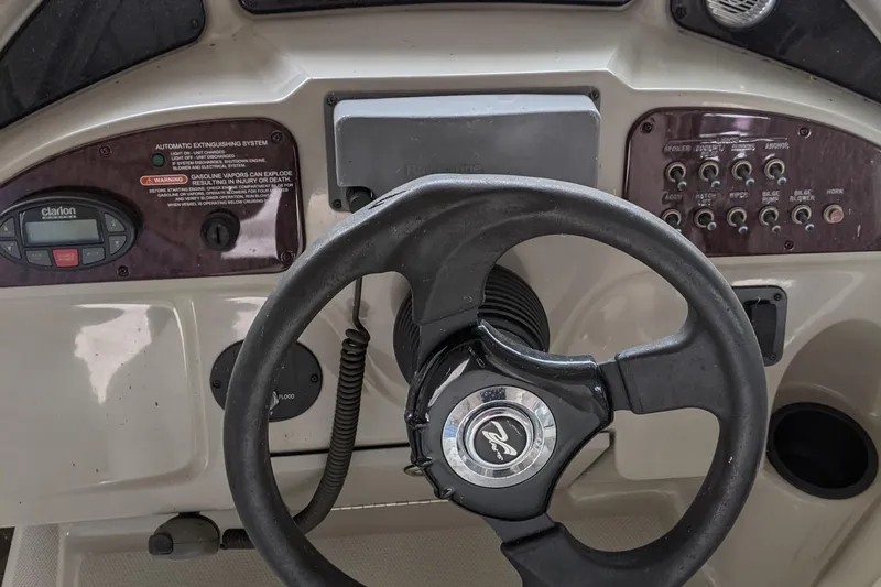 Slide: The Image of Helm of 2005 Sea Ray Sundancer 260 with steering wheel and gauges. - 12