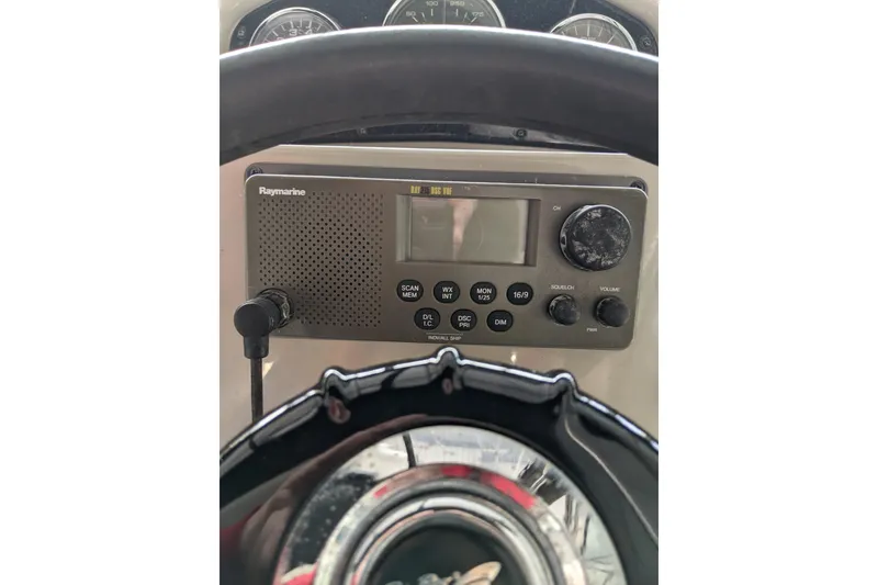 Slide: The Image of 2005 Sea Ray Sundancer 260 dashboard with Raymarine radio and steering wheel. - 15