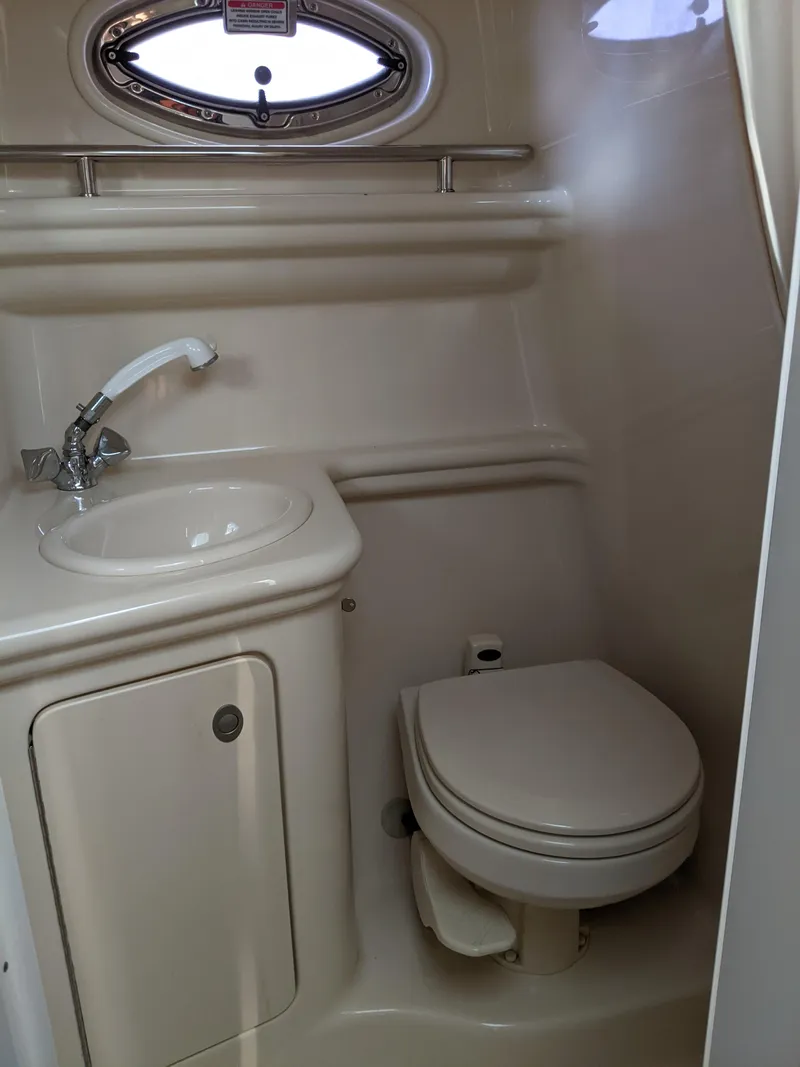 Slide: The Image of Interior of a 2005 Sea Ray 260 Sundancer with white seating. - 20