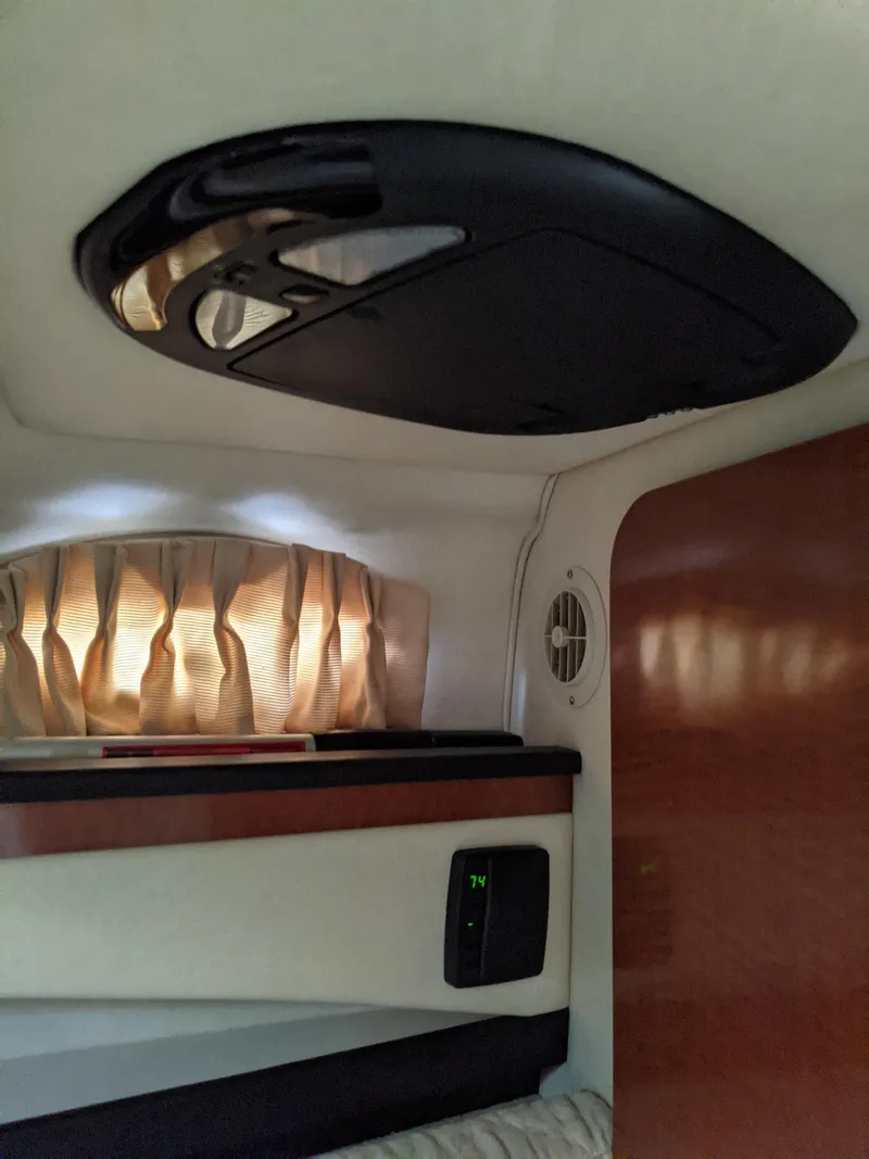 Slide: The Image of 2005 Sea Ray Sundancer 260 cabin interior with kitchenette and seating area. - 25