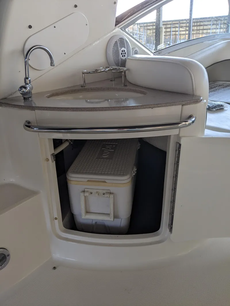Slide: The Image of Interior of 2005 Sea Ray 260 Sundancer with kitchenette and seating area. - 26