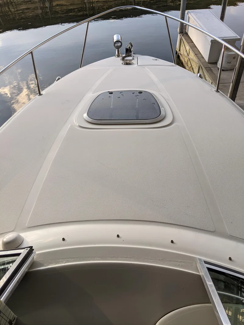 Slide: The Image of Interior of a 2005 Sea Ray 260 Sundancer with seating area and kitchenette. - 28