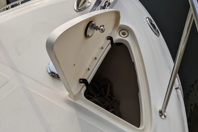 Slide: The Image of 2005 Sea Ray Sundancer 260 cabin interior with beige upholstery and black cushions. - 29