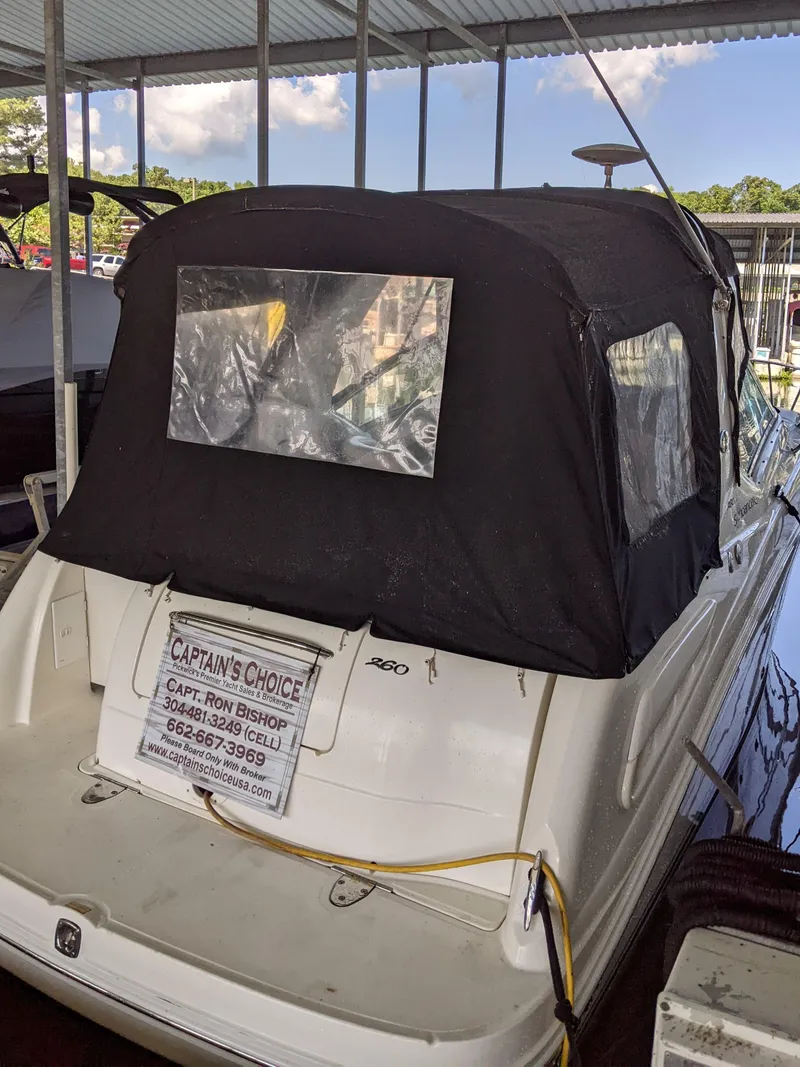 Slide: The Image of 2005 Sea Ray 260 Sundancer with black cover docked in marina. - 3