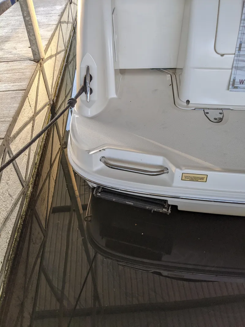 Slide: The Image of Rear view of a 2005 Sea Ray 260 Sundancer at dock. - 46