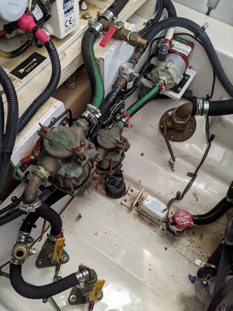 Slide: The Image of Engine compartment of a 2005 Sea Ray 260 Sundancer with hoses and valves. - 48