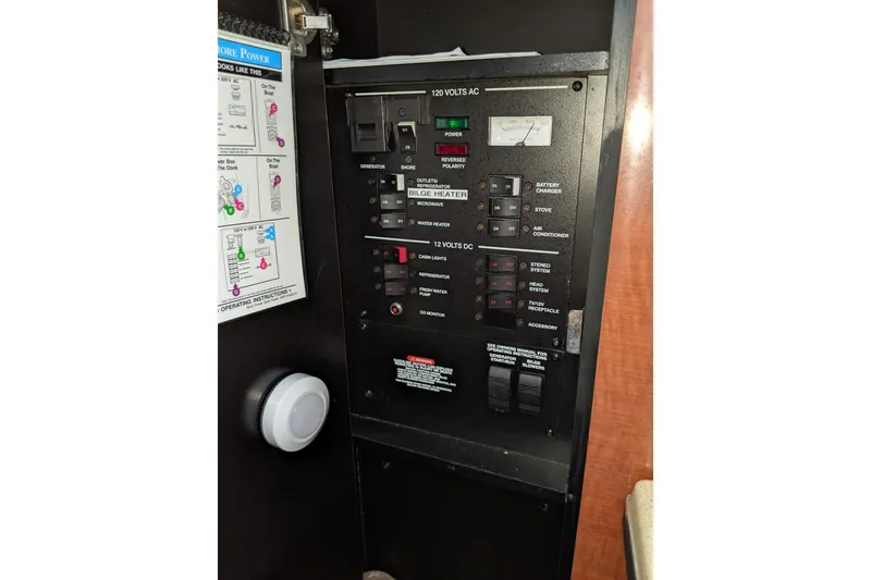 Slide: The Image of Electrical control panel on a 2005 Sea Ray Sundancer 260 boat. - 55