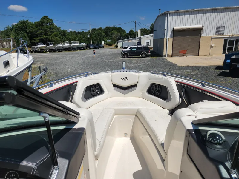 Slide: The Image of 2014 Monterey 234 SS boat interior with white seating and dashboard. - 14
