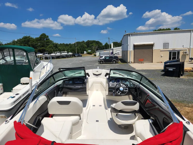 Slide: The Image of 2014 Monterey 234 SS boat with white interior, docked at a marina. - 3