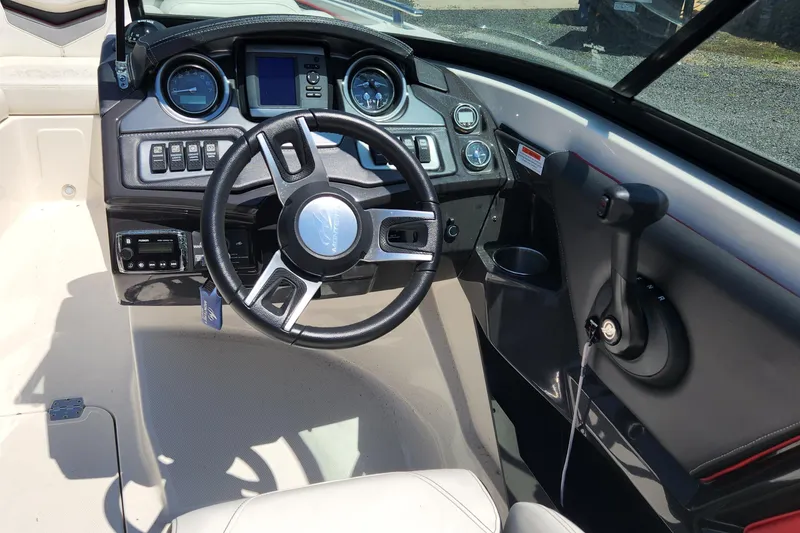 Slide: The Image of Interior cockpit of a 2014 Monterey 234 SS boat with steering wheel and control panel. - 7