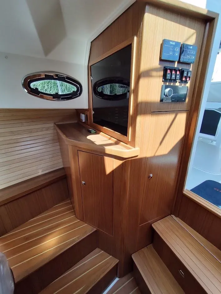 Slide: The Image of Interior of 2023 True North 34 OE yacht with wooden cabinetry and control panel. - 18