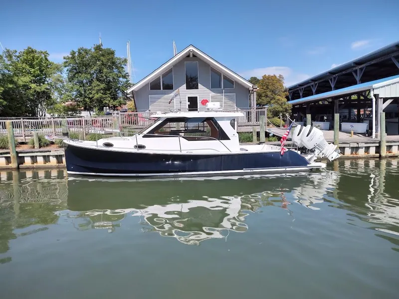 Slide: The Image of 2023 True North 34 OE boat docked by a waterfront house. - 5