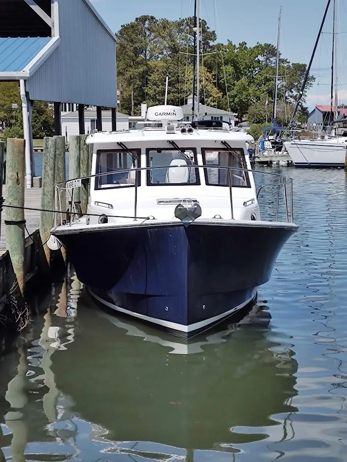 Slide: The Image of 2023 True North 34 OE boat docked at marina, front view. - 7