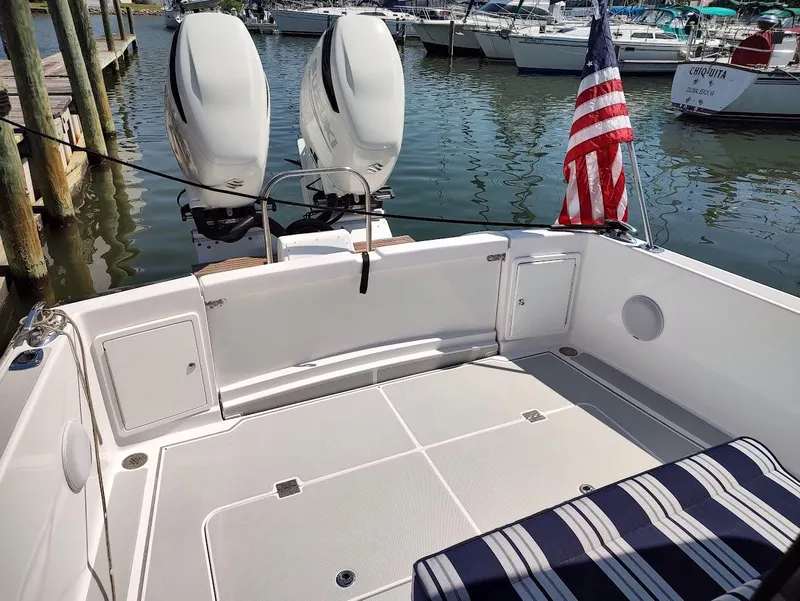 Slide: The Image of 2023 True North 34 OE boat with twin engines and American flag at marina. - 9