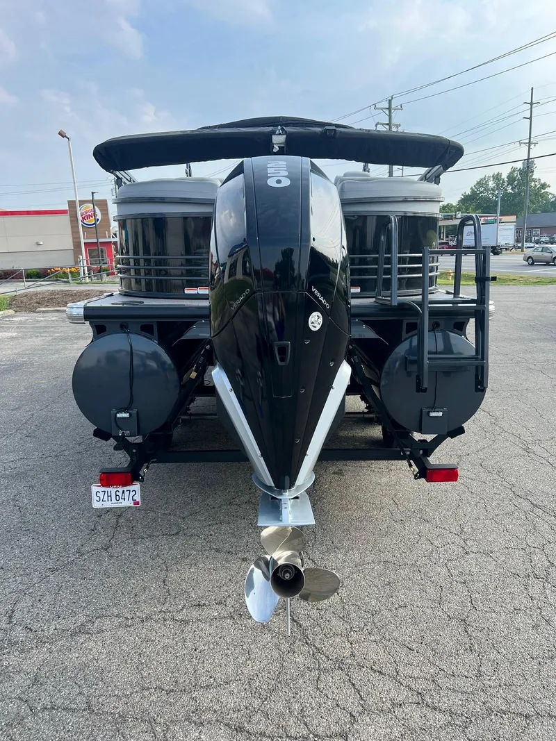 Slide: The Image of 2021 Regency 230 LE3 pontoon boat with outboard motor, rear view. - 2