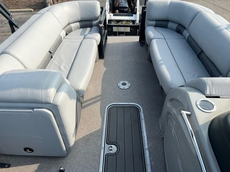 Slide: The Image of 2021 Regency 230 LE3 pontoon boat interior with gray seating and flooring. - 5