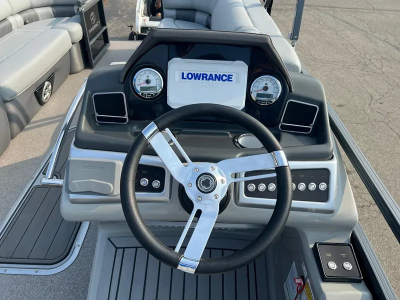 Slide: The Image of 2021 Regency 230 LE3 boat dashboard with Lowrance system and steering wheel. - 8
