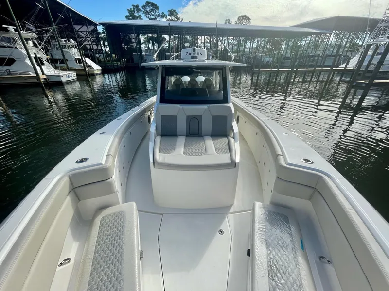 Slide: The Image of 2023 Solace 41 CS boat docked at marina, front seating area view. - 20