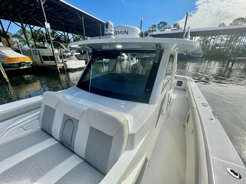 Slide: The Image of 2023 Solace 41 CS boat docked at marina, featuring Garmin electronics. - 22