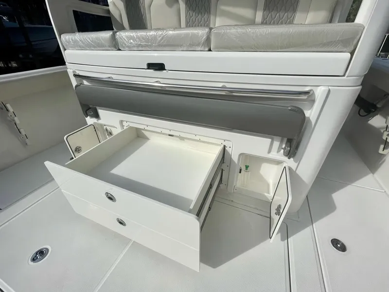 Slide: The Image of 2023 Solace 41 CS boat with open storage compartments and seating. - 31