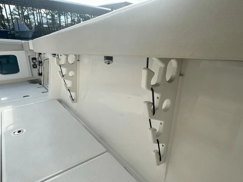 Slide: The Image of 2023 Solace 41 CS boat interior with rod holders and storage compartments. - 38