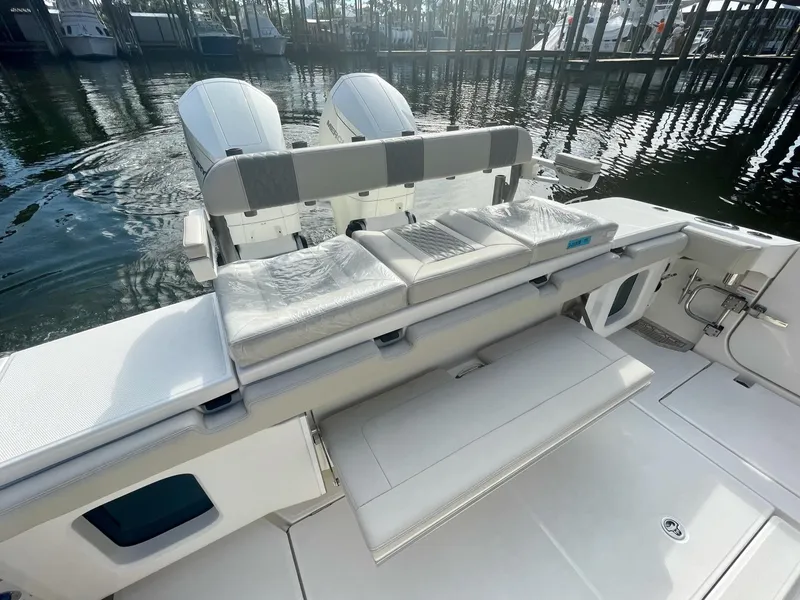 Slide: The Image of 2023 Solace 41 CS boat with dual outboard engines and cushioned seating. - 39