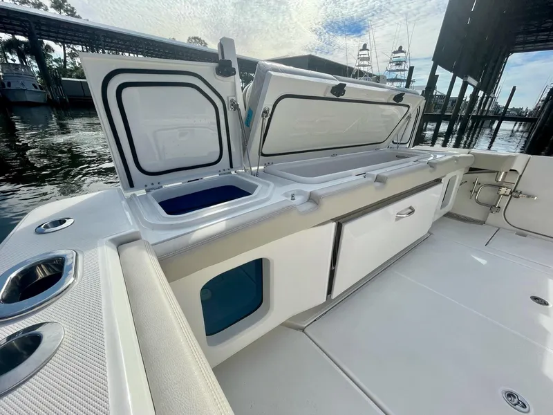 Slide: The Image of 2023 Solace 41 CS boat with open storage compartments and clean deck. - 40