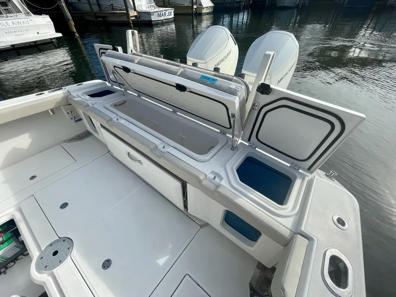 Slide: The Image of 2023 Solace 41 CS boat with open storage compartments and twin engines. - 41