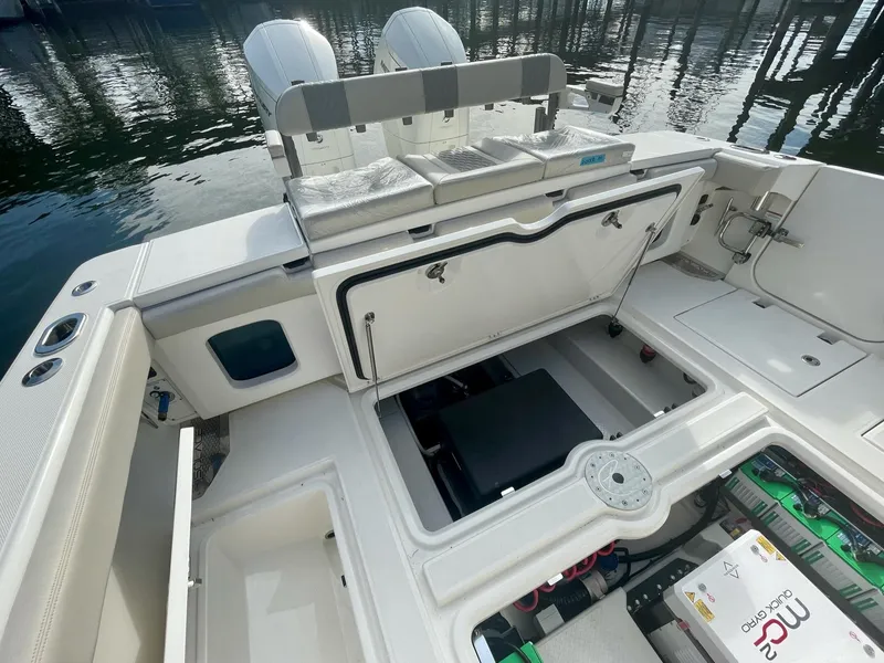 Slide: The Image of 2023 Solace 41 CS boat interior with open storage compartments and twin engines. - 46