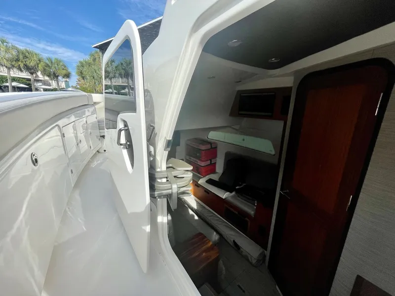 Slide: The Image of 2023 Solace 41 CS boat interior with open cabin door and seating area. - 47