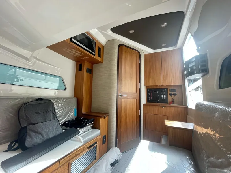 Slide: The Image of Interior cabin of 2023 Solace 41 CS boat with wooden finishes and seating. - 49