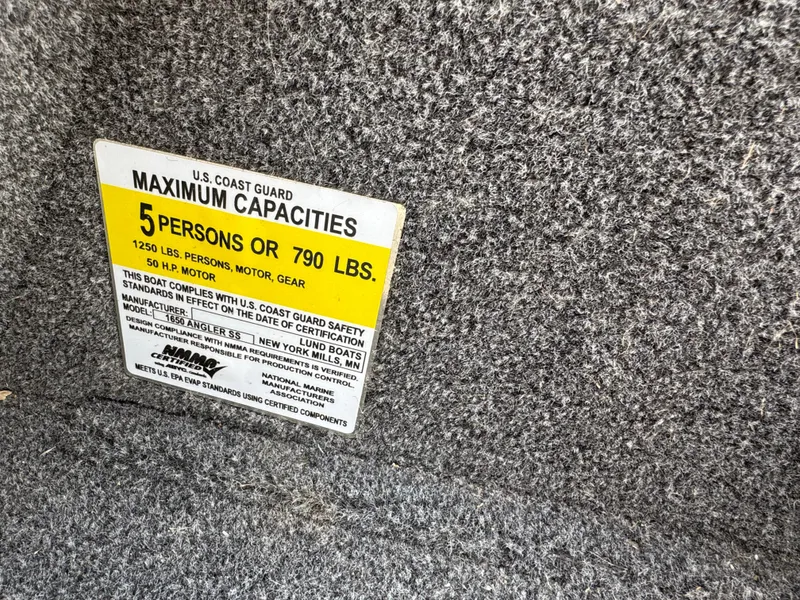 Slide: The Image of 2021 Lund 1650 Angler SS capacity label, 5 persons or 790 lbs, U.S. Coast Guard compliant. - 10
