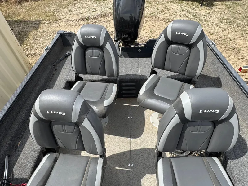 Slide: The Image of 2021 Lund 1650 Angler SS boat interior with four gray seats. - 14