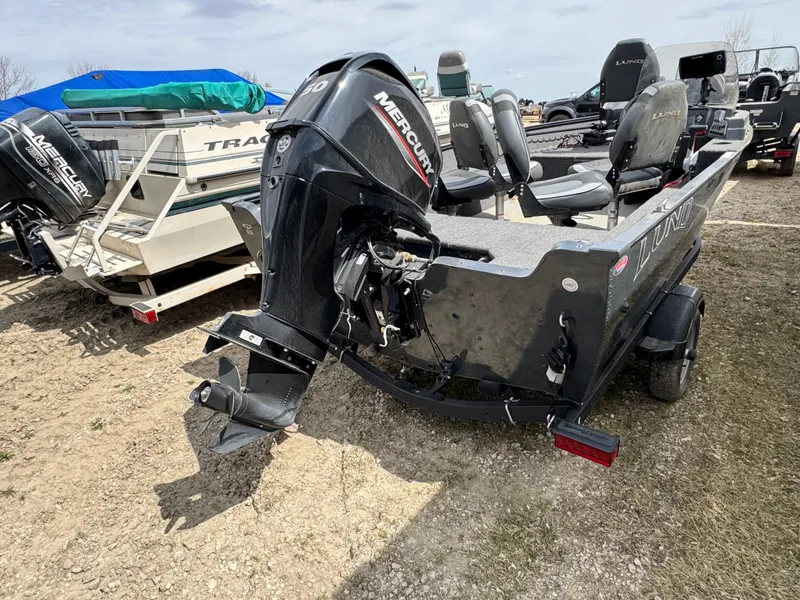 Slide: The Image of 2021 Lund 1650 Angler SS boat with Mercury outboard motor, parked on gravel. - 3
