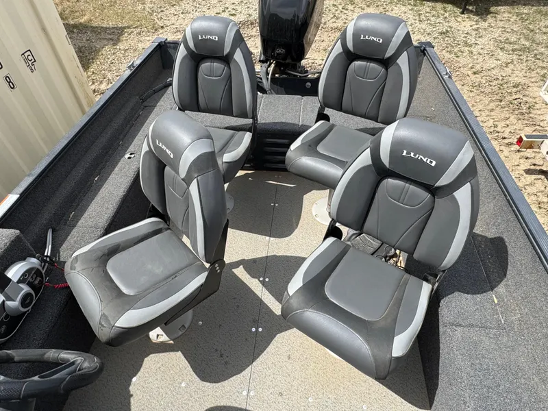 Slide: The Image of 2021 Lund 1650 Angler SS boat interior with four black and gray seats. - 5