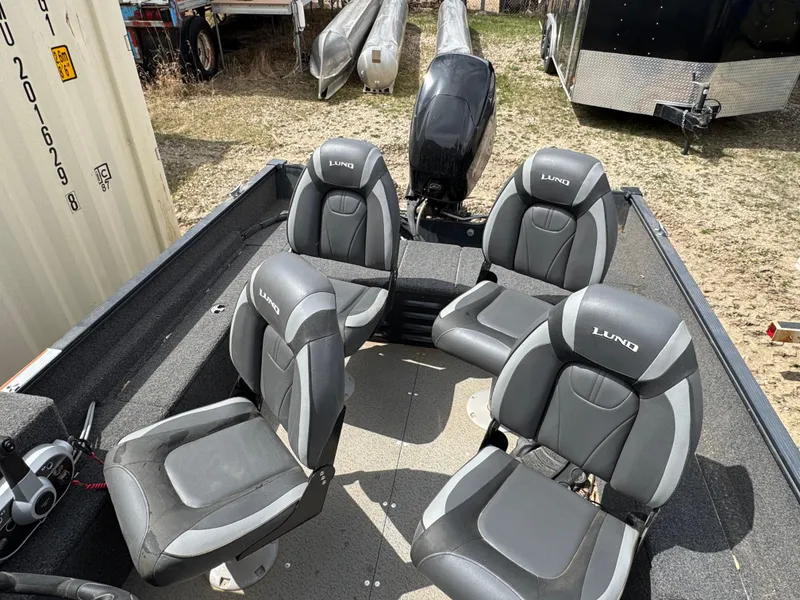 Slide: The Image of 2021 Lund 1650 Angler SS boat interior with four seats and motor. - 6