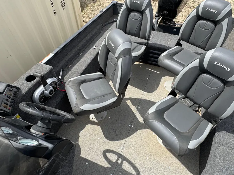 Slide: The Image of 2021 Lund 1650 Angler SS boat interior with four gray seats and steering console. - 7