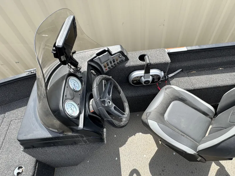 Slide: The Image of 2021 Lund 1650 Angler SS boat interior with steering wheel and control panel. - 8