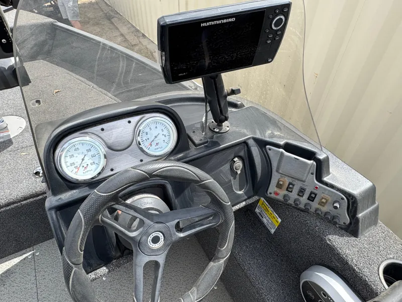Slide: The Image of 2021 Lund 1650 Angler SS dashboard with steering wheel and Humminbird fish finder. - 9