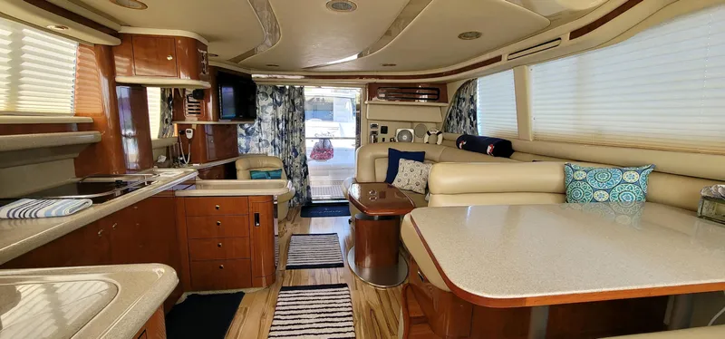 Slide: The Image of Luxurious interior of 2003 Sea Ray 480 Sedan Bridge yacht with elegant furnishings. - 12