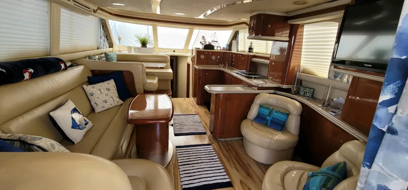 Slide: The Image of Luxurious interior of 2003 Sea Ray 480 Sedan Bridge yacht with plush seating and modern amenities. - 13