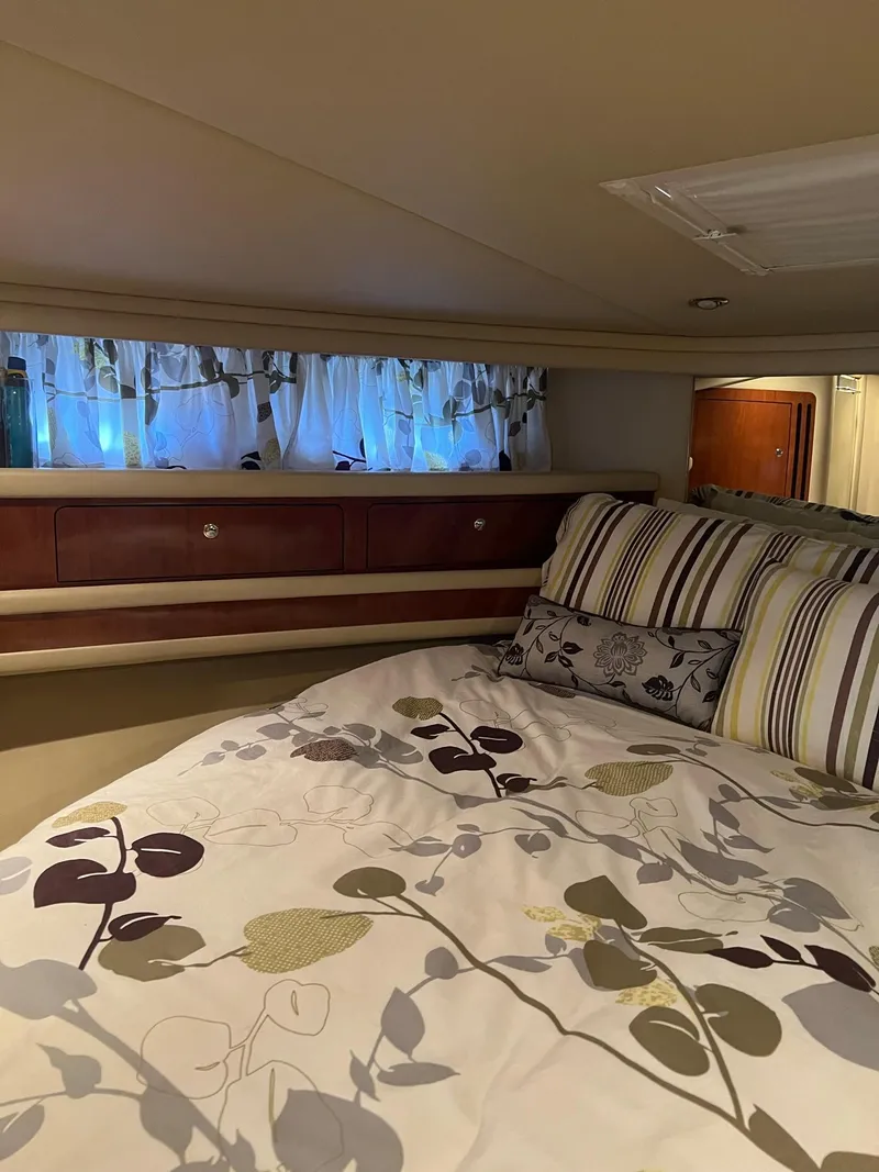 Slide: The Image of Cozy bedroom interior of 2003 Sea Ray 480 Sedan Bridge yacht with floral bedding. - 17