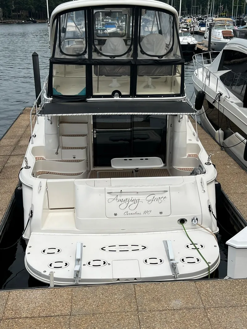 Slide: The Image of 2003 Sea Ray 480 Sedan Bridge docked at marina, rear view. - 2
