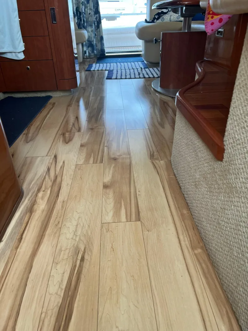 Slide: The Image of Interior of 2003 Sea Ray 480 Sedan Bridge with polished wooden flooring. - 30