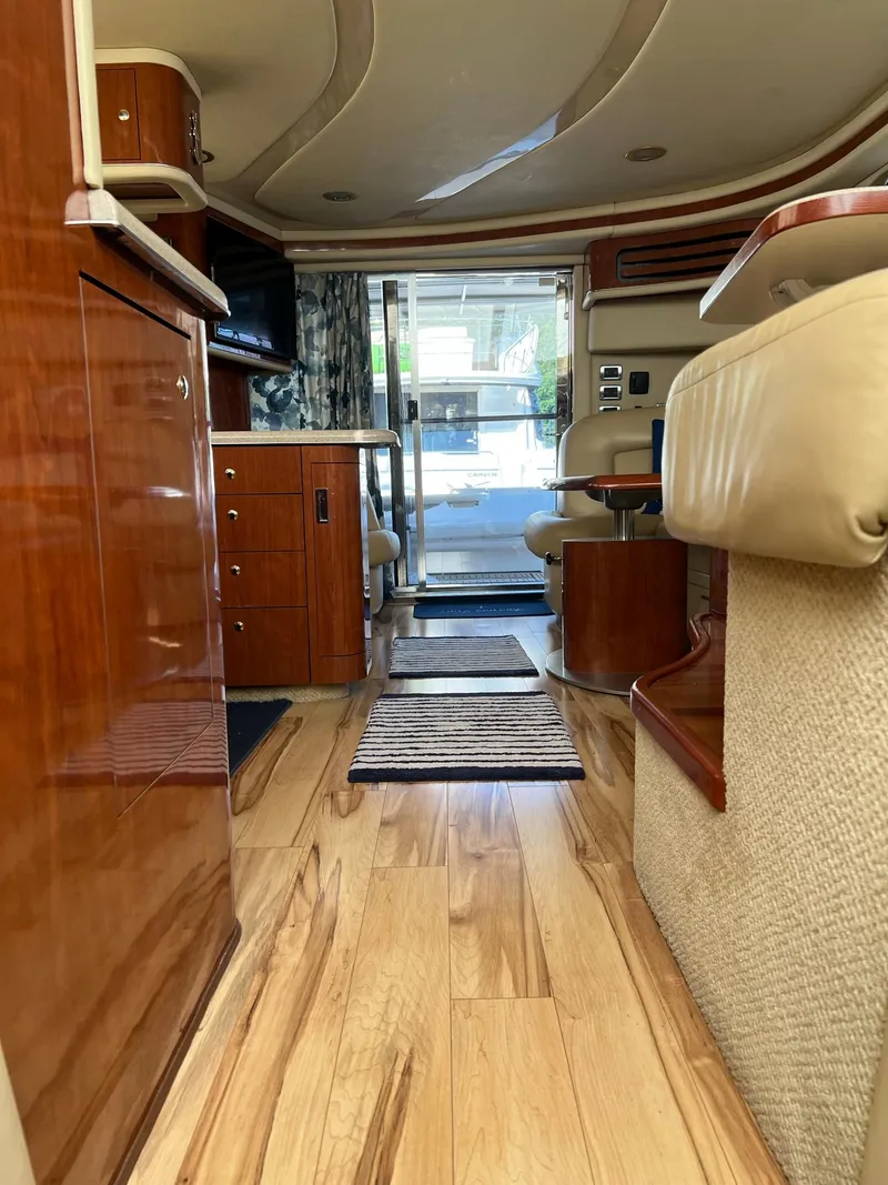 Slide: The Image of Interior of 2003 Sea Ray 480 Sedan Bridge with wood flooring and elegant seating. - 31
