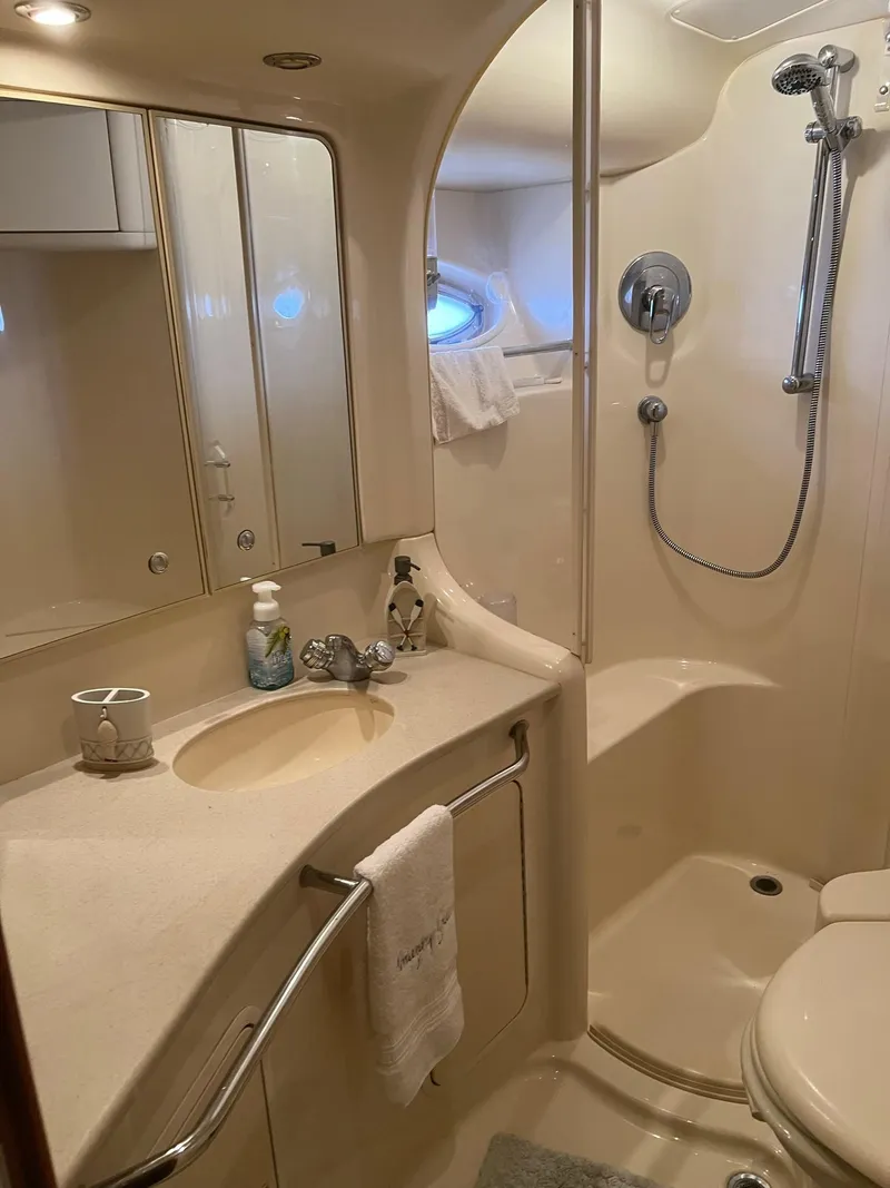 Slide: The Image of Bathroom interior of 2003 Sea Ray 480 Sedan Bridge yacht, featuring shower and sink. - 32