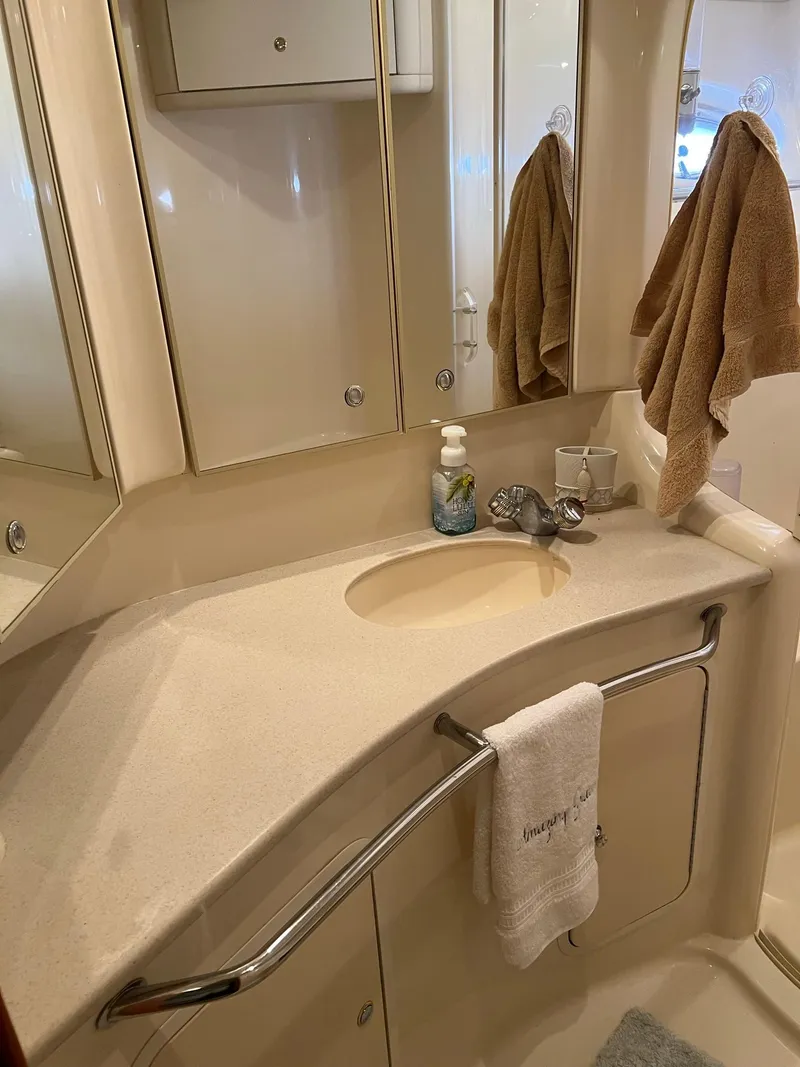 Slide: The Image of Bathroom interior of 2003 Sea Ray 480 Sedan Bridge yacht, featuring sink and mirror. - 38